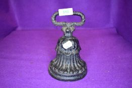 A cast iron Victorian door stop in a bell shape design