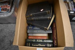 A box of books including novels and more.