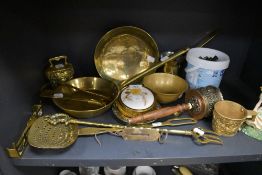 A varied lot of brass items amongst which are embossed cow bell, spring balance, bowls, pan and