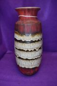 A large statement piece of west German pottery having red matte ground with textured brown bands and
