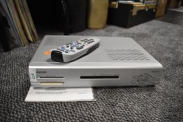 A Panasonic digital sky television box with manual.
