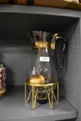 A retro Pyrex coffee jug and stand.