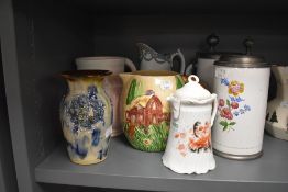A mixed selection of jugs,vases and tankards including Shorter jug with cottage design and blue