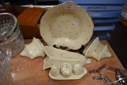 A selection of art deco Bursley ware wall pockets, a cruet set and a cake plate, all having simple
