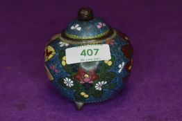 A cloisonne koro having three foot base with decoration of flowers on blue ground