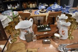 A selection of drinking items including water jugs chased wine goblets and gentlemans shaving items