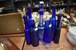 A selection of Bristol blue bottles and similar cruet set