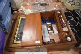 A writing slope having internal compartments and two ink wells with brackets to sides of casing.AF.