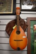 A vintage sunburst flat back (slight bowl) mandolin , not labelled, with soft bag