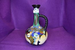 A Gouda pottery vase 'Corona' Having multi coloured ground with leaf and floral type abstract