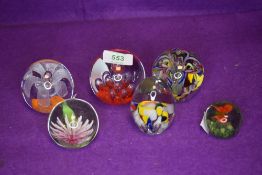 A selection of art glass paper weights having centre designs in flower and butterfly designs