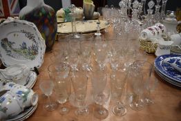 A mixed lot of vintage and antique glasses and decanters including etched examples and cut glass.