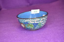 A cloisonne pot or bowl with flowers on blue ground and key decoration approx 10cm accross