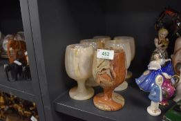 Six Onyx or similar goblets, one with repair.