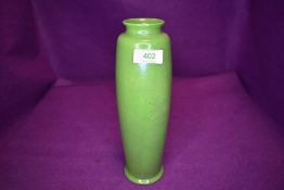 A slender Ruskin vase having green ground with lustre finish, Impressed to underside with Ruskin