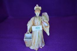 A 19th century bisque/ porcelain Chinese figure with nodding head.