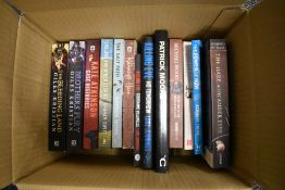 A selection of action and fantasy books including Patrick Moore on the Moon
