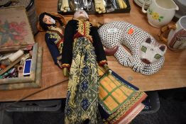 Two ethnic style puppets and a wooden cat.