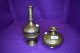Two brass vases having embossed motifs and scenes.