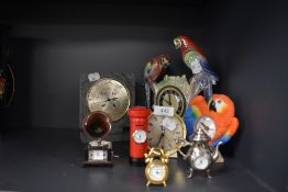 A selection of vintage and modern clocks including bright lustre finish parrot mantel clock embossed