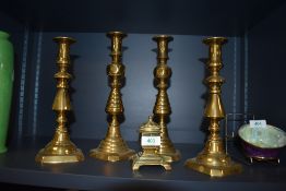 A collection of brass candle sticks and and antique ink well having W.T & S impressed to underside.