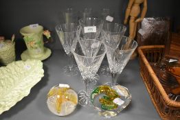 Two paperweights and a selection of glasses.