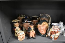 A collection of character jugs and series ware jugs including Royal Doulton.