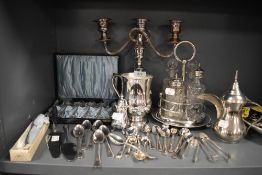 An assortment of plated ware and cutlery including candle stick holder,boxed tea spoons, condiment