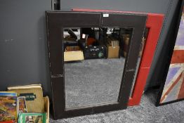 A pair of modern mirrors having leather frame in brown and red colour ways