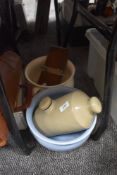 Two chamber pots, a tie press and a stone hot water bottle.