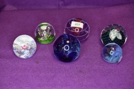 A fine selection of art glass paper weights by Caithness including hand signed