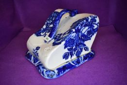 A large blue and white Ironstone cheese dome having large blue rose pattern.