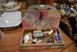 A vintage sewing bow and a travel case containing a variety of haberdashery.