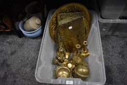 A box of vintage brass amongst which are four embossed plaques having phrases and sayings, chargers,