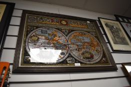 A framed vintage mirror having map decoration.