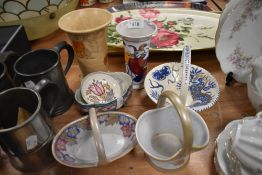 A collection of ceramics, predominantly Charlotte Rhead designs including posy baskets, vases and