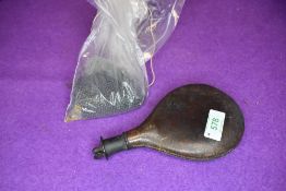 An antique hunters shot flask or pellet pouch having leather body and brass fitments