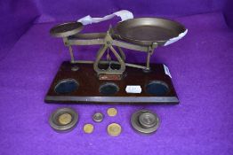A wood and brass set of Johnsons of Hendon scales and weights.