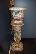A Capodimonte jardinière having embossed classical scenes with cherubs, foliage and similar.