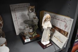 Two Giuseppe Armani figurines with certificates, owls on nest and holy communion girl.