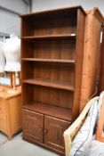 A late C20th oak effect bookshelf with cupboard under, approx w 80cm