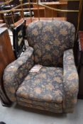 A nice quality early 20th Century low seat armchair having blue foliate upholstery