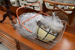A selection of light fittings and shades in traditional wire shopping basket