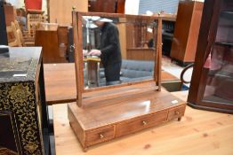 An Edwardian toilet mirror having triple drawer base, width approx. 61cm