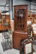 A reproduction mahogany corner display cabinet with lower cabinet section