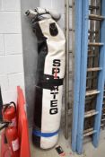 A vintage boxing punch bag and gloves