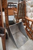 A galvanised garden or feed barrow