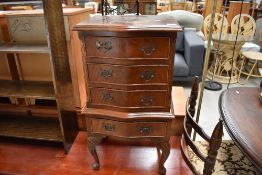 A reproduction mahogany serpentine front bedroom chest of four drawers, Reprodux or similar quality