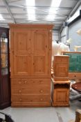 A modern pine drawer base wardrobe, approx w 105cm, a bedside cabinet, and a similar cabinet