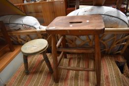 An early C20th beech frame milking stool and a similar period stool